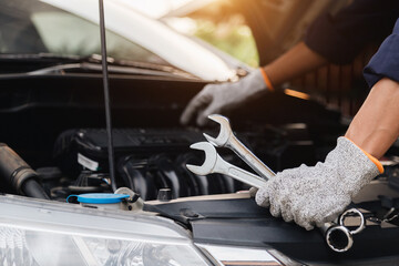 Automobile mechanic repairman hands repairing a car engine automotive workshop with a wrench, car service and maintenance,Repair service.