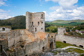 Obraz premium Stone gothic ruins of old medieval castle Rabi in National Park Sumava, ancient fortress in sunny spring day, landmark in countryside, stronghold on the hill, Rabi, Czech Republic