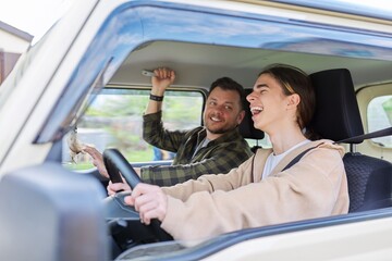 Father teaching his teenage son to drive