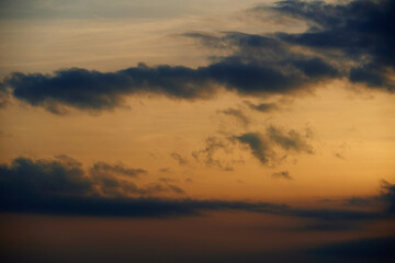 beautiful sunset sky, dark silhouette of clouds as a background