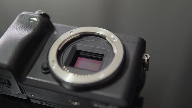 Professional mirrorless camera body ready for cleaning the sensor of the lens