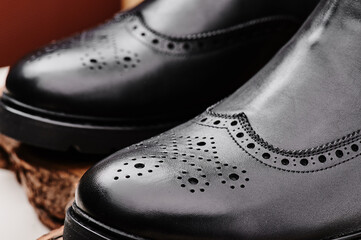 Black leather chelsea boots made of genuine leather in classic style close-up. High quality photo