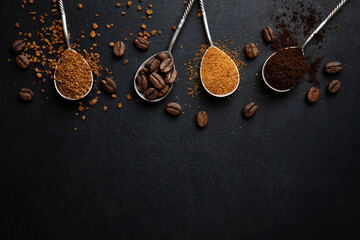 Coffee in different spoons on dark background