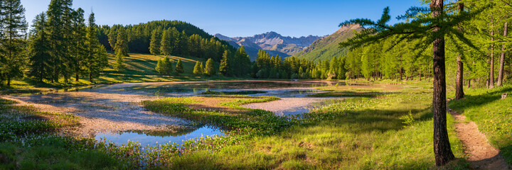 Lac de Roue lake in the Queyras Nature Park late Spring -early Summer (panoramic). Hiking site near Arvieux in the Hautes-Alpes, French Alps, France