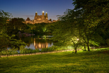 Fototapeta na wymiar Central Park lake at night in Summer with view on Upper West Side buildings. New York City, Manhattan, NYC