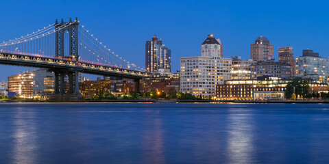 Fototapeta na wymiar Brooklyn waterfront next to the Manhattan Bridge (DUMBO neighborhood - Main Street Park) at twilight with the East River. New York City