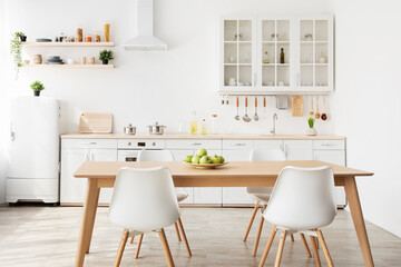 Minimalist scandinavian style. Dining room and light kitchen design with wooden table and white furniture, copy space
