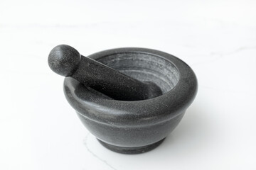 Black Stone Mortar and Pestle Isolated on White marble table