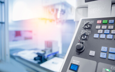 Control panel of CNC machine at factory floor to get metal detail production with sunlight