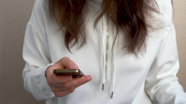 Close-up of a woman with a phone in her hand.