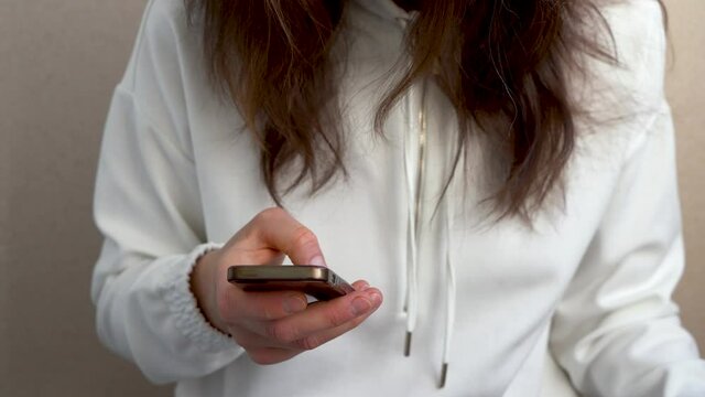 Close-up of a woman with a phone in her hand.