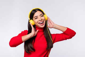 Photo of happy good mod charming pretty young girl enjoying listening music in headphones isolated...