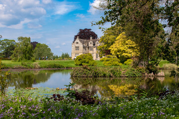 beautiful manor house by the lake spring summer day. 