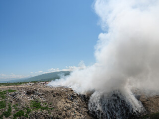 Fototapeta na wymiar Fire at a household waste dump. Environmental pollution, disaster.