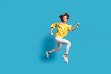 Fototapeta na wymiar Full body profile side photo of happy woman jump run empty space smile sale isolated on pastel blue color background