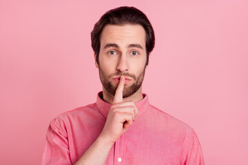 Photo of silent unhappy young man hold finger mouth lips secret rumor mistake isolated on pink...