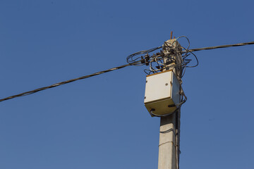 Distribution transformer box and electricity line on concrete pole