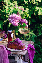 Lavender glaze cake on a table in a spring garden..style vintage