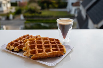 Belgian sugar waffles with black coffee served outdoor