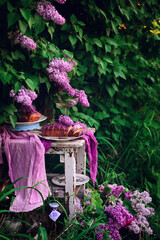 Lavender glaze cake on a table in a spring garden..style vintage
