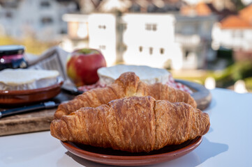 French breakfast with fresh baked croissants and cheeses from Normandy, camembert and neufchatel served outdoor with nice city view
