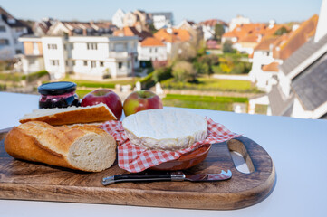 French breakfast with fresh baked baguette bread and camembert chees from Normandy, served outdoor with nice city view