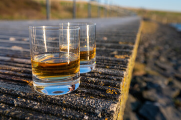 Drinking single malt Scotch whisky at sunset with sea, ocean or river view, private whisky tours in Scotland, UK