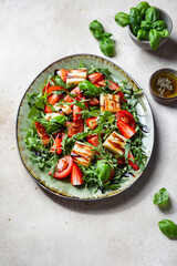 salad with strawberries, tomatoes and halloumi cheese