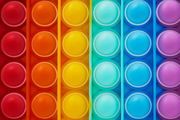 Multicolor poppit toy on a white background, close-up