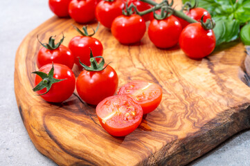 Ripe small round sweet red cherry tomatoes close up