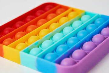 Multicolor poppit toy on a white background, close-up