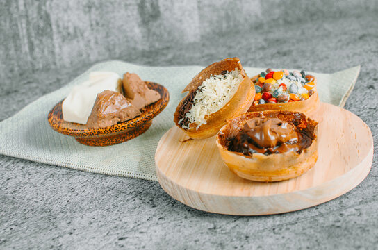 Martabak Manis is Indonesia dessert. Sweet Martabak with chocolate, cheese, peanut. this picture in white background and blurry, selective object.