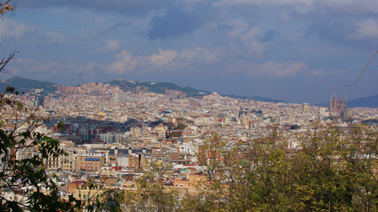 Fototapeta na wymiar Barcelona, Catalunya: A cityscape from the famous Parc Guell, under a beautiful blue sky.
