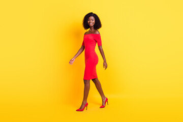 Fototapeta na wymiar Full length profile portrait of satisfied dark skin person look camera bare shoulders isolated on yellow color background