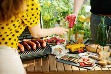 table with electric grill and grilled sausages