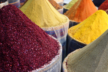 Traditional oriental spice market or bazaar. Various spices on the counter close-up. Selective focus