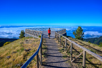 Hiker in Madeira Island - View Point of mountain scenery of the highland - tabove the clouds -...