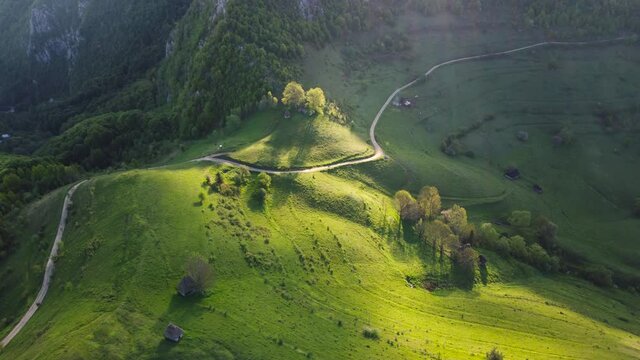 Mountain views with green hills, during spring. Aerial view of Dumesti village from Apuseni Mountains, Romania