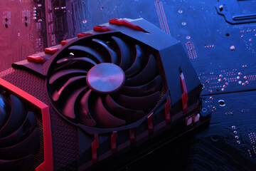 Computer game graphics card, videocard with two coolers on circuit board ,motherboard background....