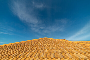 Close up of brown clay roof tiles. Red old dirty roof. Old roof tiles. Construction equipment build a house.