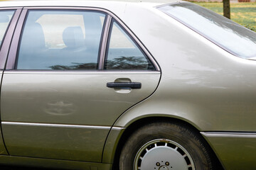 Close-up of the rear door of an old car