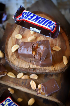 Kharkiv Ukraine June 08 2020 Mini Snickers and peanuts on wooden surface. Snickers advertising.