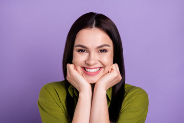 Photo of funny dreamy young woman wear khaki outfit arms cheeks smiling isolated violet color background