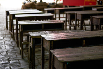 Close-up of desks and chairs in school classrooms in poor areas