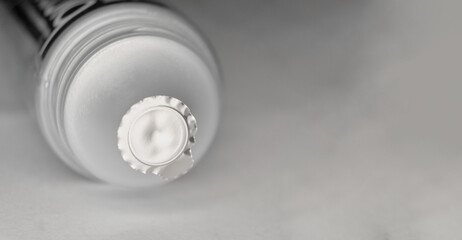 Macro tube of toothpaste on a gray background, copyspace