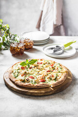 Hot melting cheese pizza. Italian traditional food on a light concrete background.