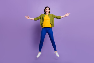 Full size photo of young cheerful girl happy positive smile jump up isolated over purple color background