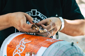 hands of the person making a lace