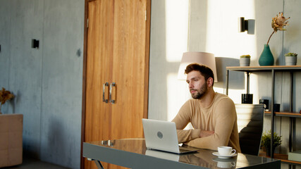 Handsome worker with laptop computer indoor