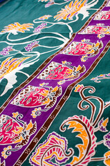Batik is the art of painting cloth using wax and natural or artificial coloring. Close up colorful and beautiful batik fabric. Javanese batik. Indonesian batik.